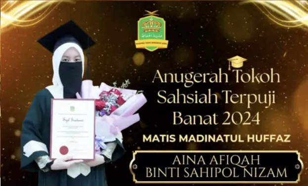 Pelajar hafizah cemerlang Aina Afiqah Binti Sahipol Nizam menerima Anugerah Tokoh Sahsiah Terpuji Banat 2024 di Matis Madinatul Huffaz.