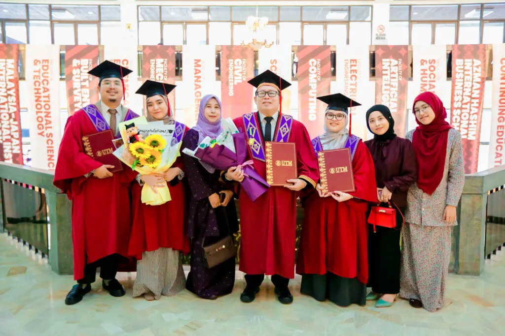 Seorang graduan UTM bergambar bersama keluarga termasuk anak dan menantu sempena majlis konvokesyen.